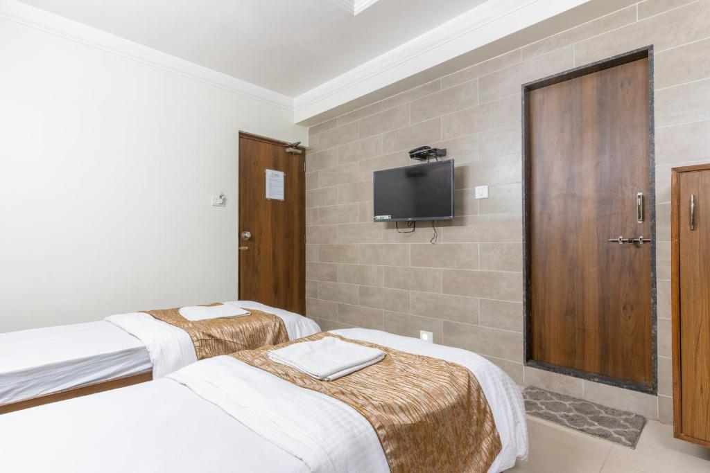Postel nebo postele na pokoji v ubytování Hotel Sanmati