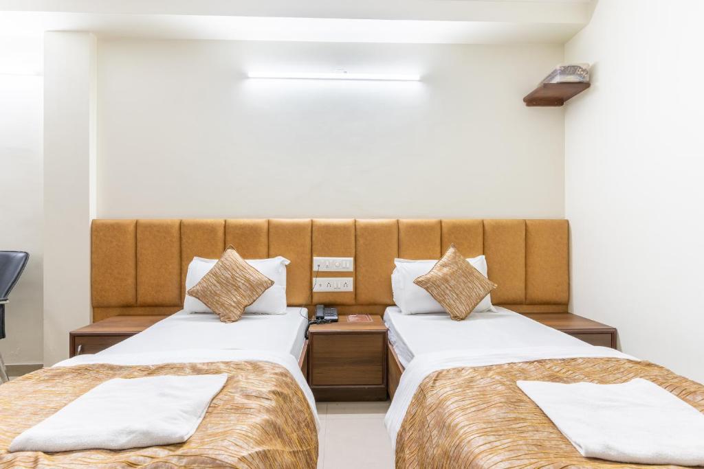 Postel nebo postele na pokoji v ubytování Hotel Sanmati