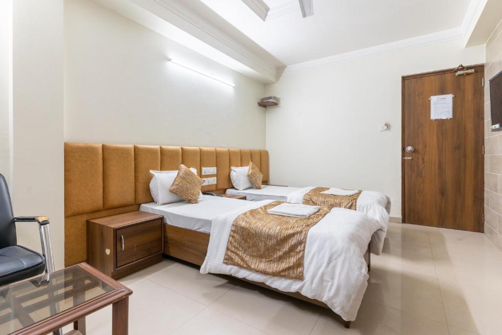 Postel nebo postele na pokoji v ubytování Hotel Sanmati