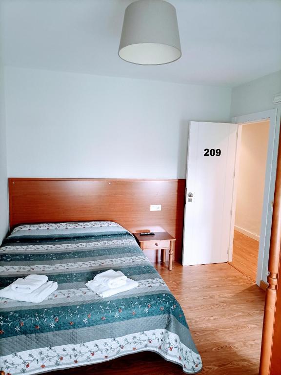Postel nebo postele na pokoji v ubytování HOSTAL ALTO PÁRAMO