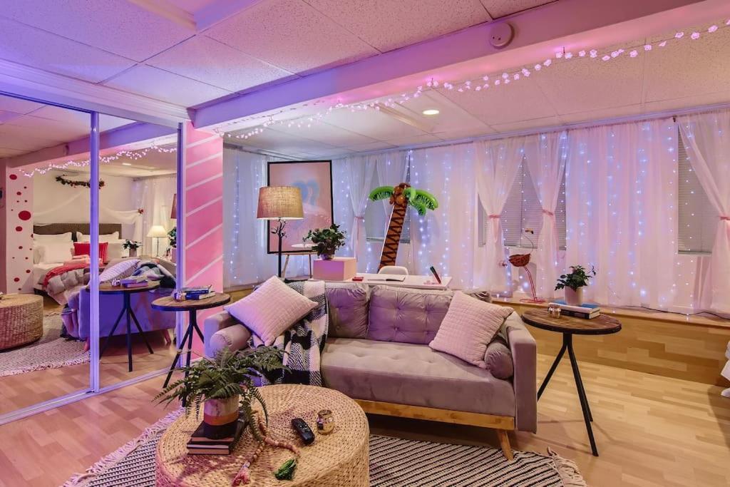 a living room with a couch and a giraffe backdrop at Barbie's Dream Apt in the City in Sacramento