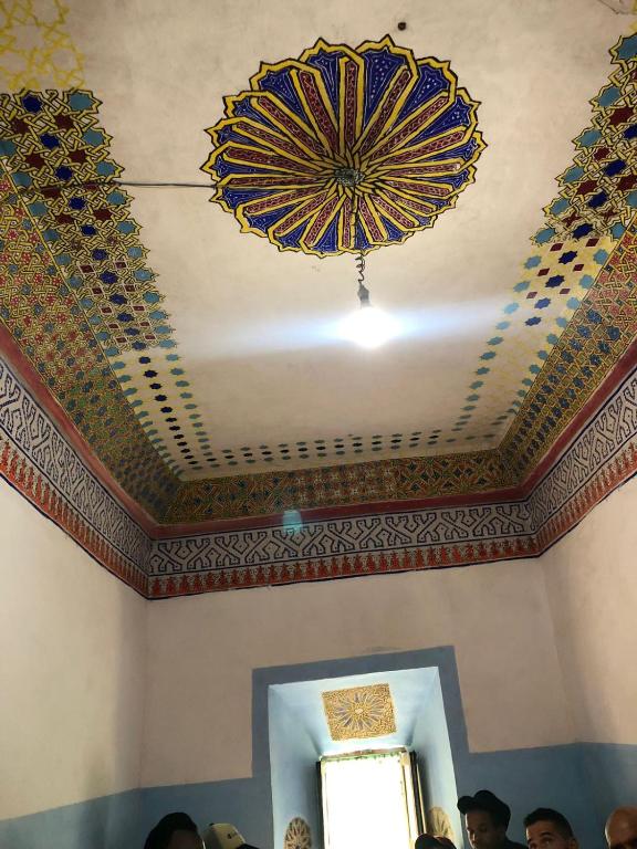a ceiling of a room with a blue and gold umbrella at Gite Ifoulou Tassaout in Ifoulou