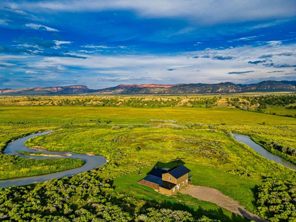 an aerial view of a house in a field next to a river at Sevier River Retreat in Hatch