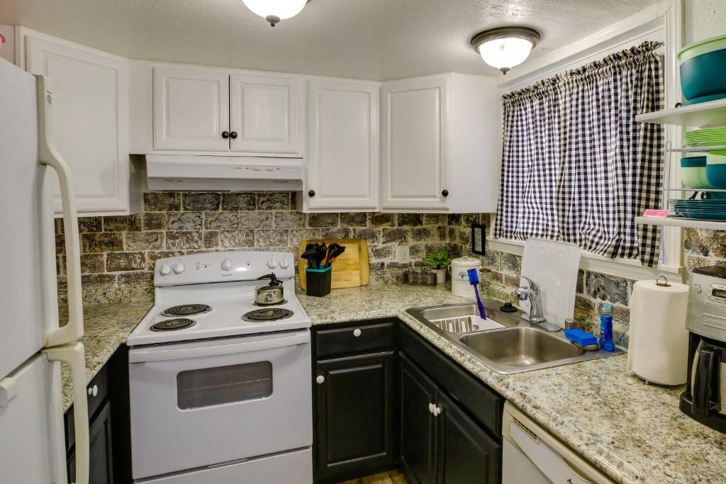 a kitchen with a white stove and a sink at Cozy Wasilla Apartment about 2 Mi to Downtown! in Wasilla