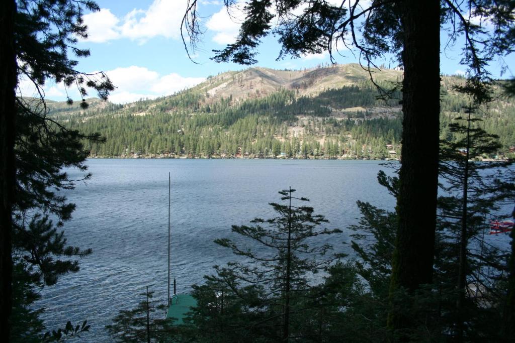 a view of a lake through the trees at 2 bedroom and Loft, 2 bath, sleeps 6 Donner Lakefront with private dock DLR#013 in Truckee