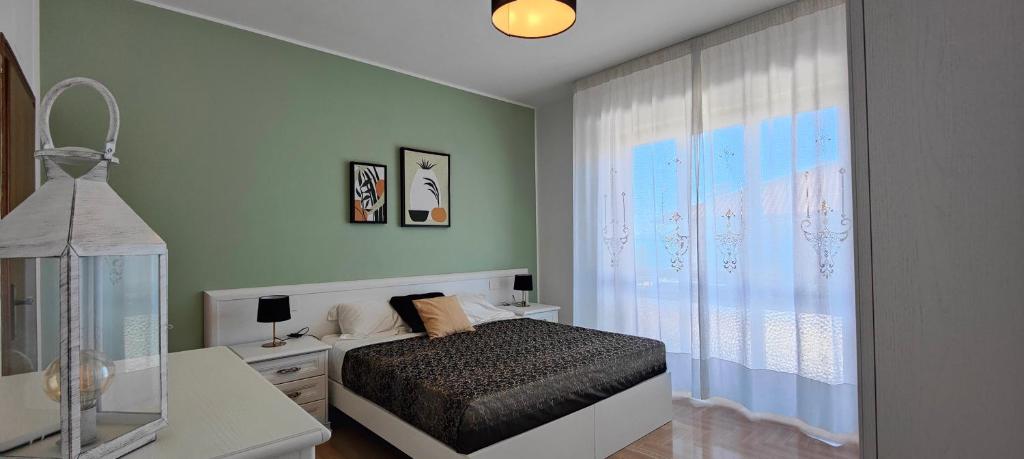 a bedroom with a bed and a window at Case Gioto e Bellavista in Passignano sul Trasimeno