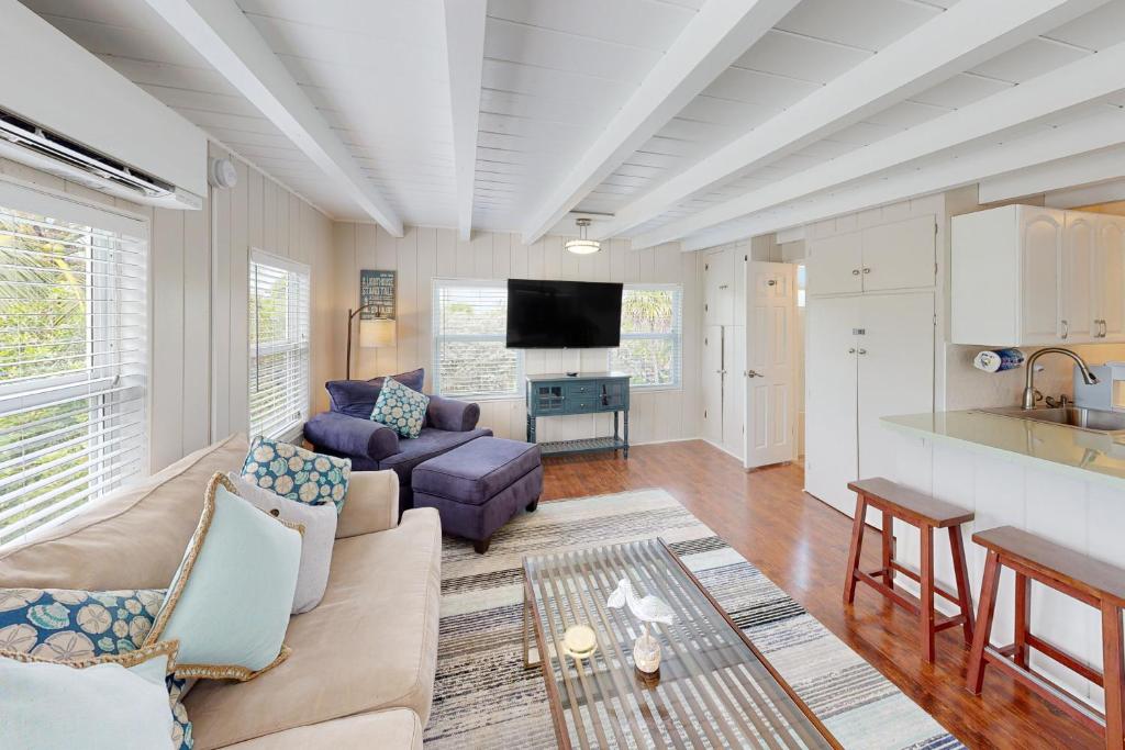 a living room with a couch and a kitchen at Sombrero Suite in Marathon