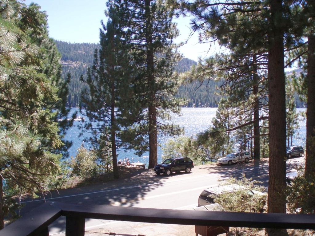 a car parked on a road next to a lake at 2 bedroom, 2 bath, sleeps 6 Direct Donner Lake Access DLR#038 in Truckee