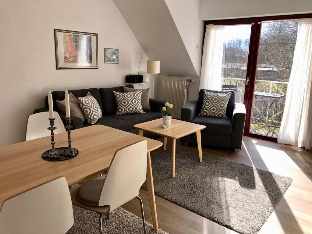 a living room with a couch and a table at Ferienwohnung-Nils-Holgerson-mit-Balkon-zwischen-Strand-Wald-Wiese-im-Suedosten-der-Insel-Ruegen in Gustow