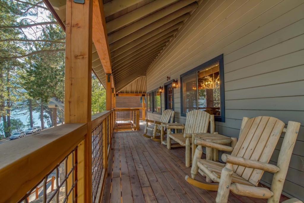 a porch with rocking chairs on a house at 3 bedroom, 2 bath Sleeps 8 adults Direct Lake Access DLR#041 in Truckee