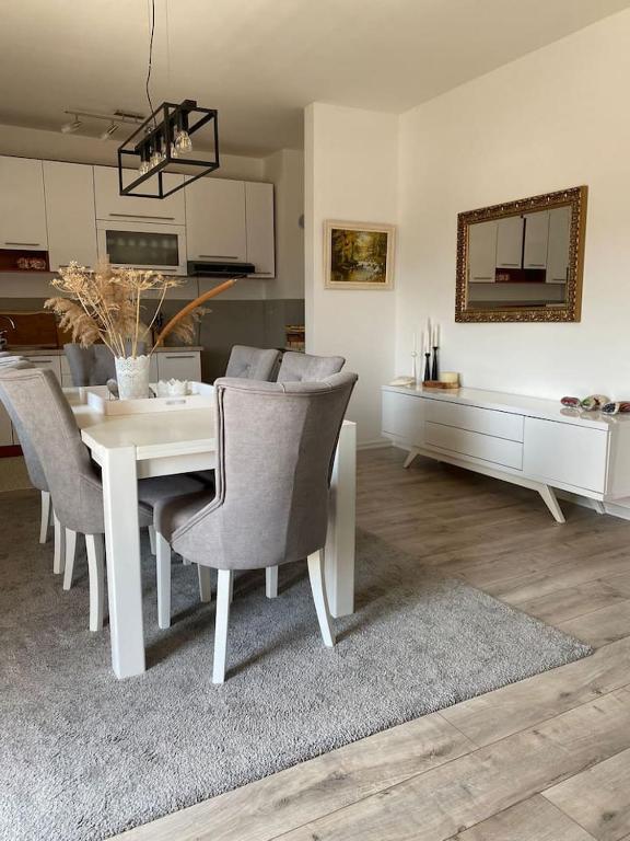 a dining room with a white table and chairs at Apartment Angelina 