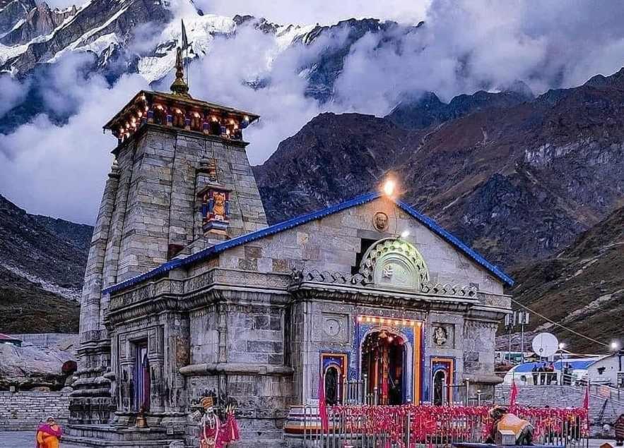 an old church with a mountain in the background at Kedarnath Tent Prithvi yatra Hotel in Kedārnāth