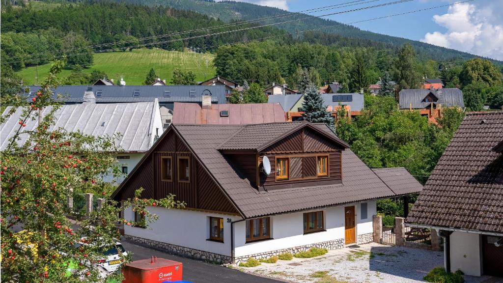 a house with a brown roof in a village at Vakantiehuis Cerny Dul 38 in Černý Dŭl