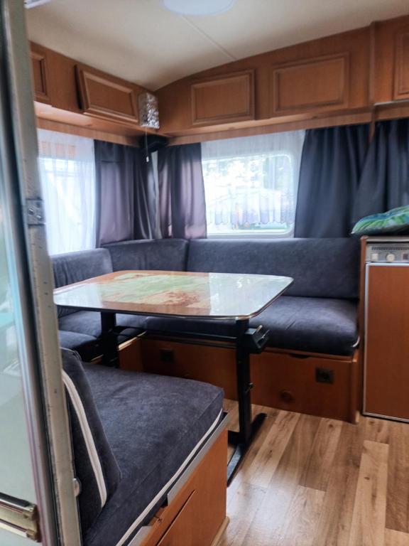 a table in the back of an rv with a table at Kemping prywatny na ośrodku in Gąski