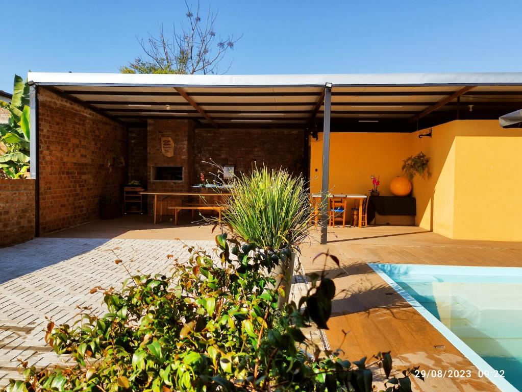a house with a swimming pool and a patio at Casa com piscina e Quiosque! in Encantado