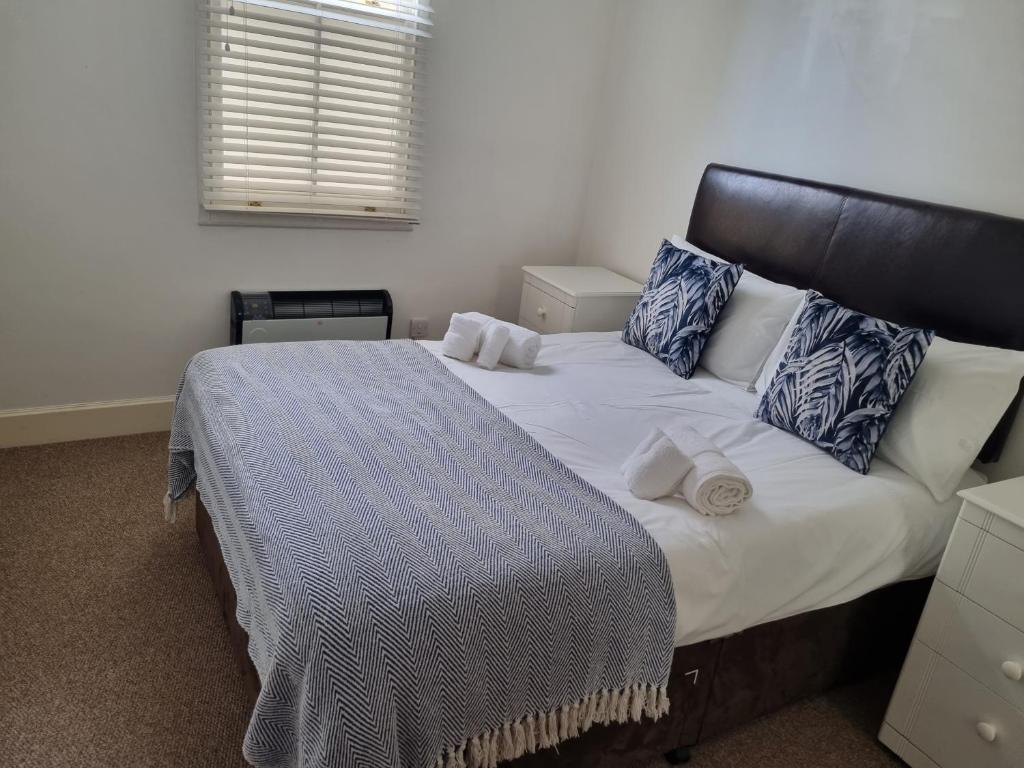 ein Schlafzimmer mit einem großen Bett mit blauen und weißen Kissen in der Unterkunft Stunning 2 Bed/2 Bath Flat in Waterloo, London in London