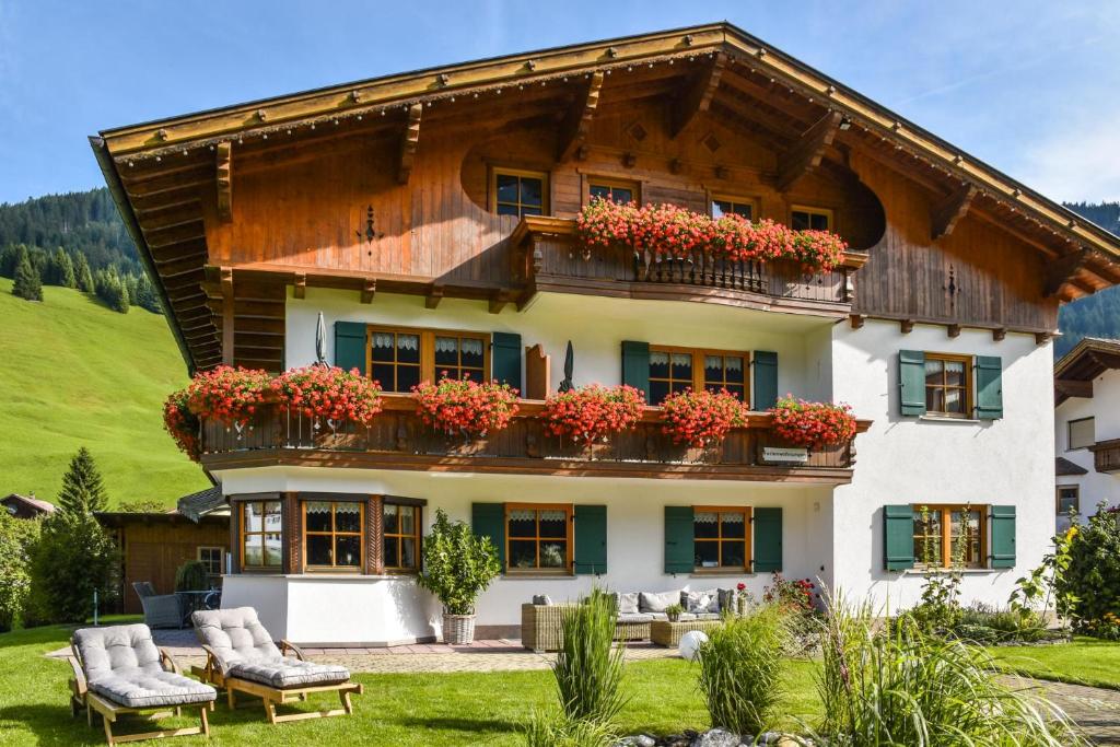 a house with flowers on the balconies of it at Landhaus Bernhard in Holzgau
