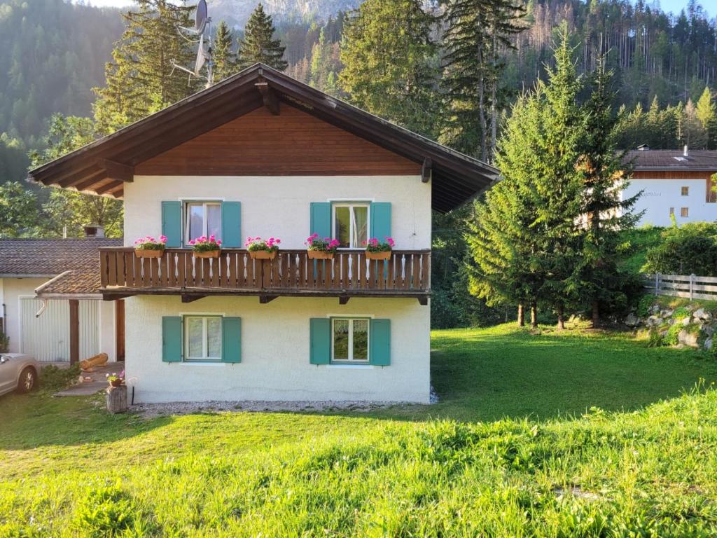 a house with a balcony with flowers on it at Relax al lago di Braies in Braies