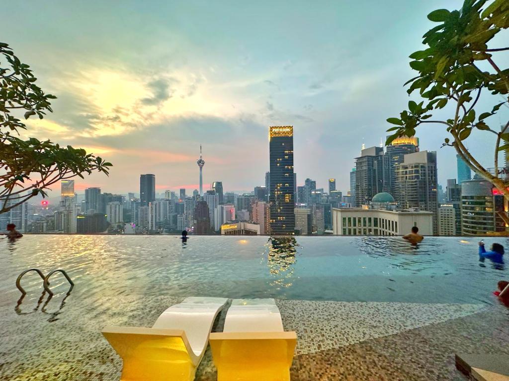 a swimming pool with a city skyline in the background at Axon Residence By Perkasa Suites in Kuala Lumpur