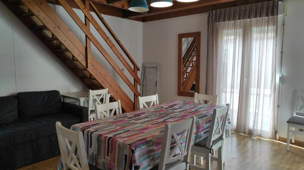 un salon avec une table, des chaises et un canapé dans l'établissement Villa duplex Soustons plage,, à Soustons