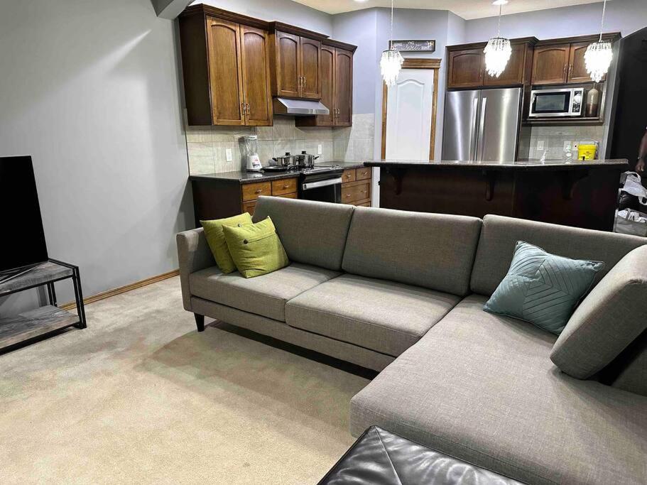 a living room with a couch and a kitchen at Spacious, 2-story Family-Friendly home in Calgary