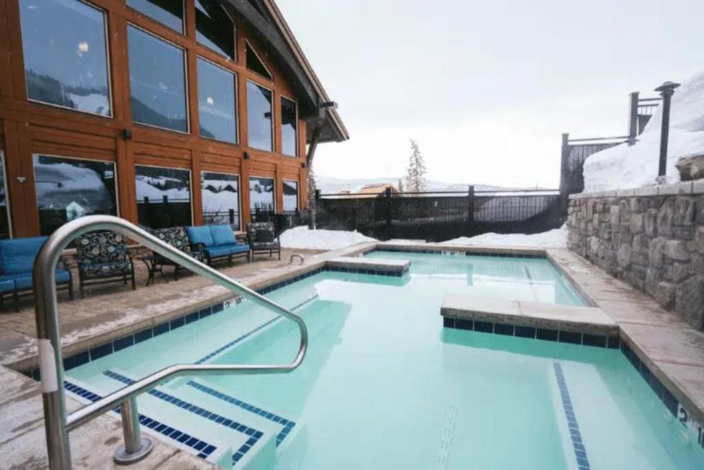 a swimming pool in front of a building at Twilight View in Durango Mountain Resort