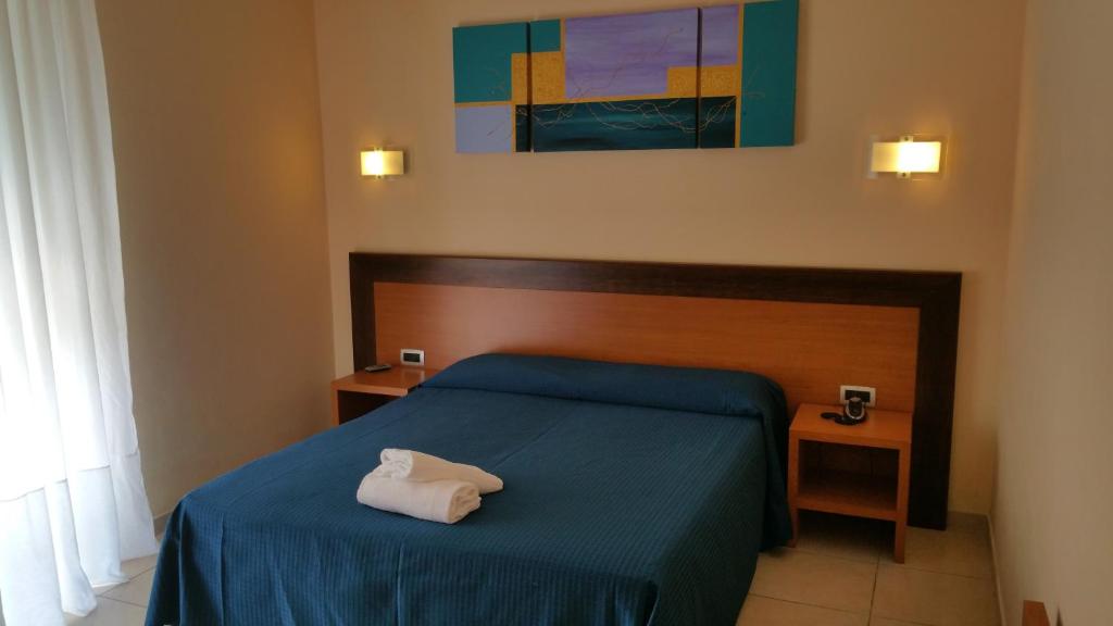 Postel nebo postele na pokoji v ubytování Hotel Club Koiné