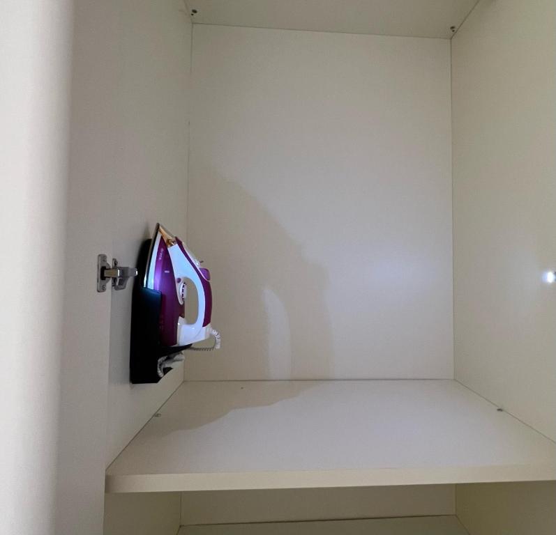 a room with a shelf and a clock on the wall at S a p p h i r e H o M e - Rivarolo DesignApartment in Rivarolo Canavese