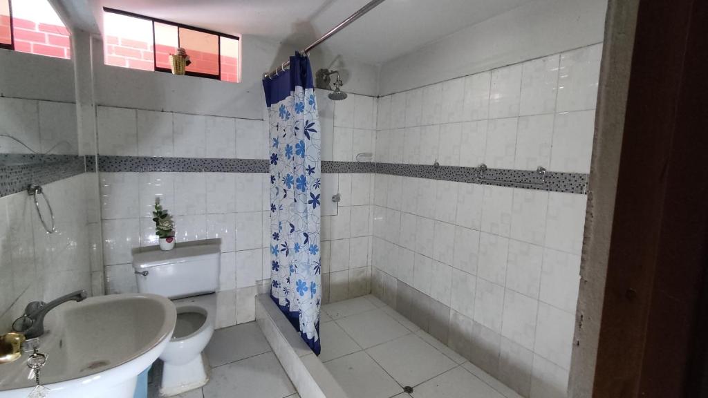 a bathroom with a tub and a toilet and a sink at Bello Amanecer in Las Palmas