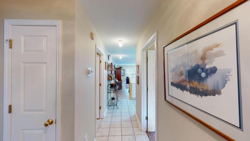 a hallway with a large painting on the wall at Spacious 3BR Villa Groups of Six in Pawleys Island in Pawleys Island