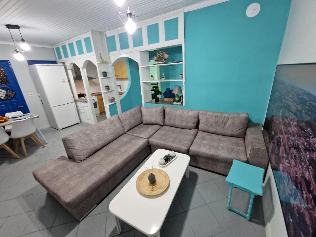 a living room with a couch and a table at MYKONOS OF THRACE in Paralía Avdhíron