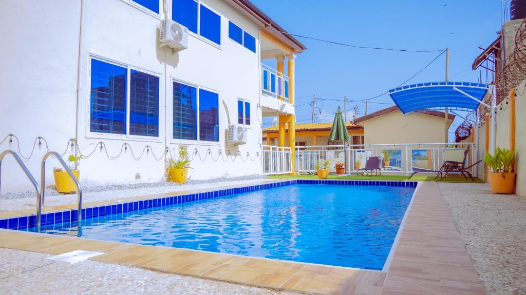 a swimming pool in front of a house at Pool House Retreat in Accra in Accra