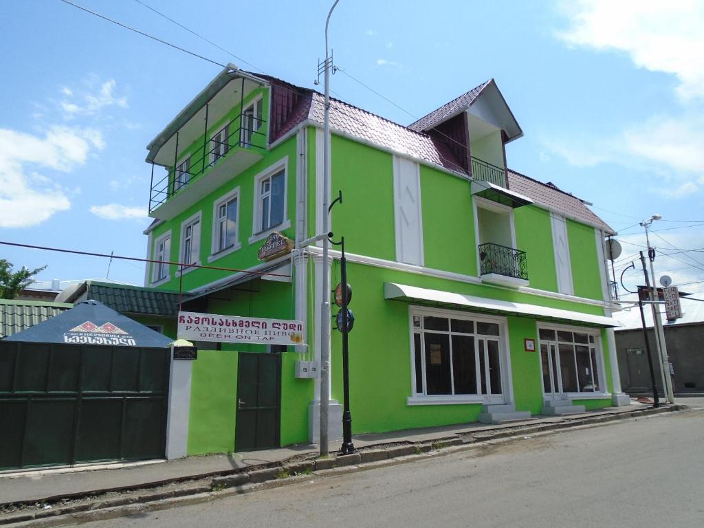 a green and white building on the side of a street at Hotel Star in Akhaltsikhe