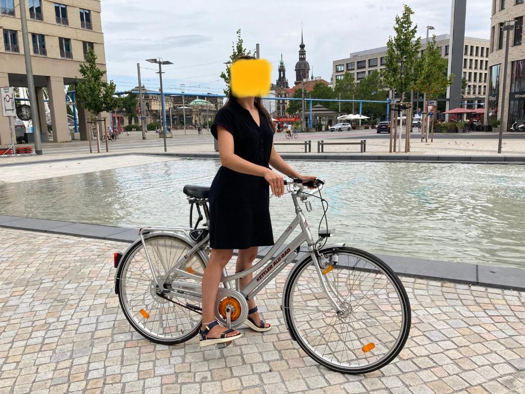 a woman with a yellow hat on her bike at Premium City Apartment Dresden in Dresden