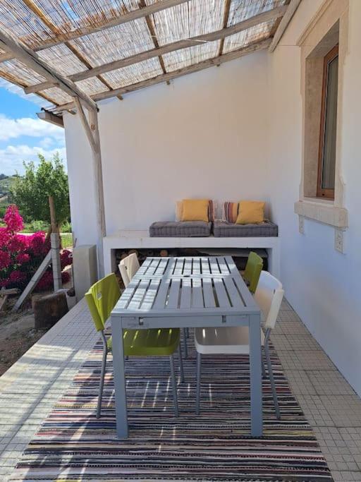 a blue table and chairs on a patio at Refúgio no Oeste com Vistas Perto Óbidos e Praias in Landal