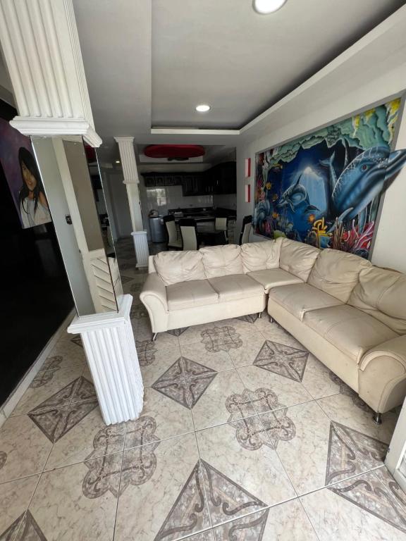 a living room with a white couch and a painting at Apartamento amoblado CARTAGENA in Cartagena de Indias