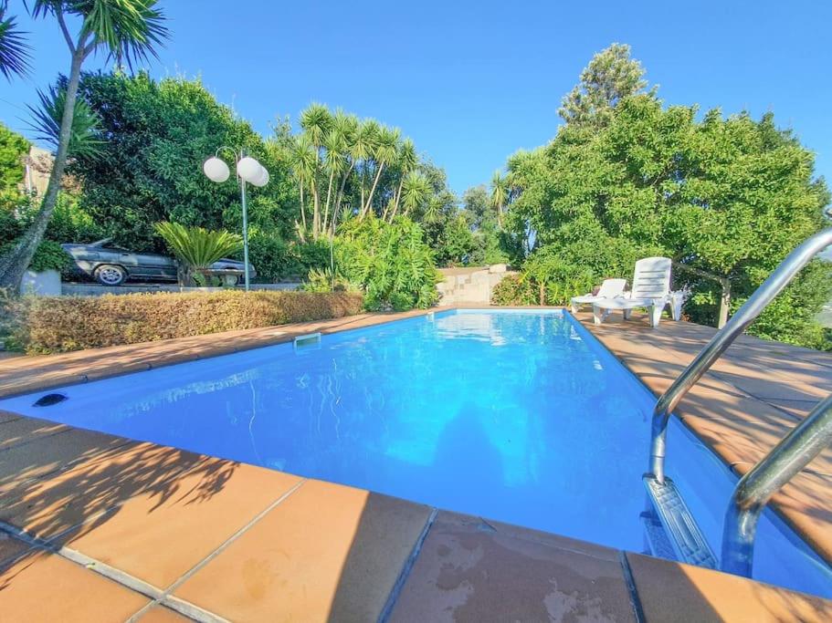 uma piscina num quintal com uma cadeira em Quintinha das Laranjeiras em Santa Cruz do Douro