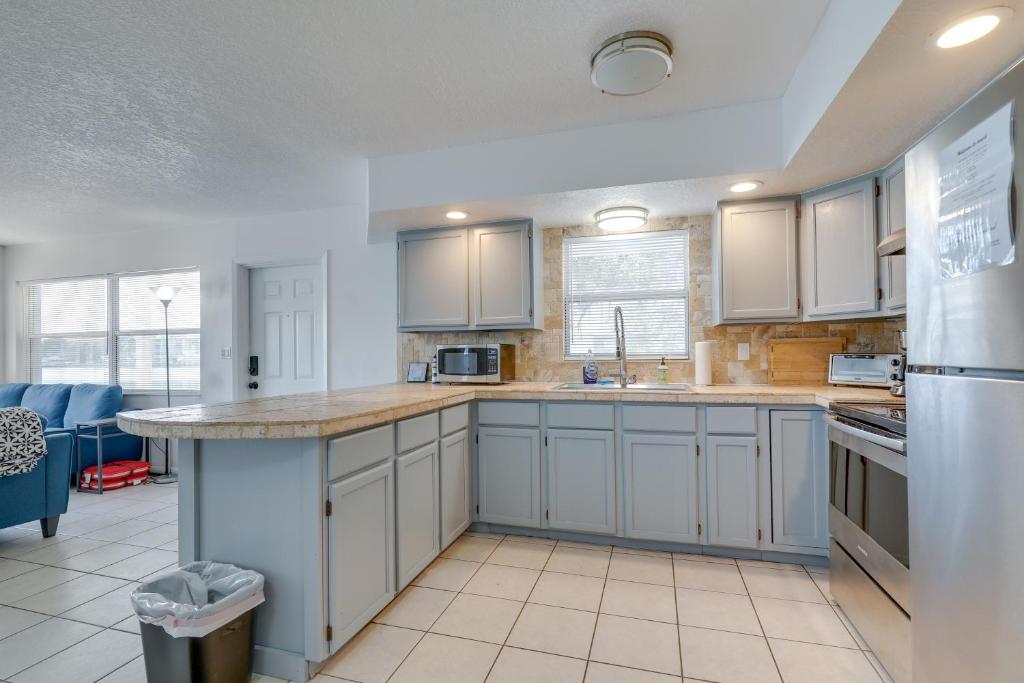 a kitchen with white cabinets and a large island at Florida Condo with Intracoastal Waterway Views! in Clearwater Beach