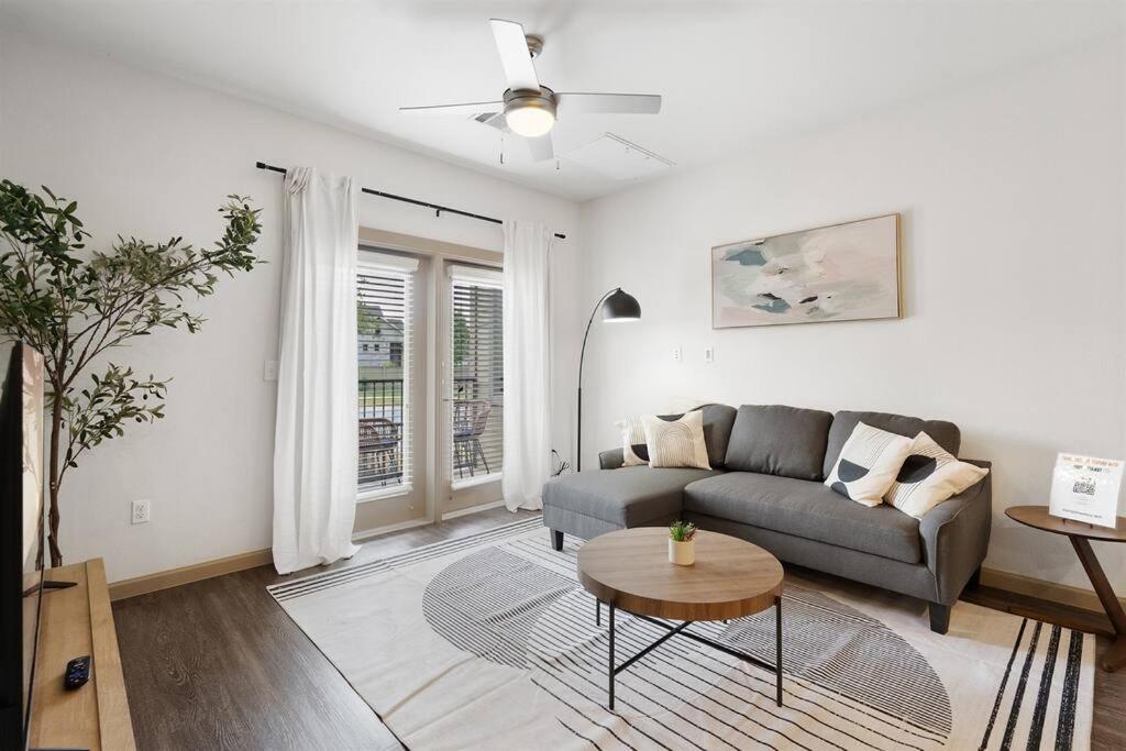 a living room with a couch and a table at Luxe 2B/2B Getaway - Pool, Gym, Garage, Pet Wash in Leander