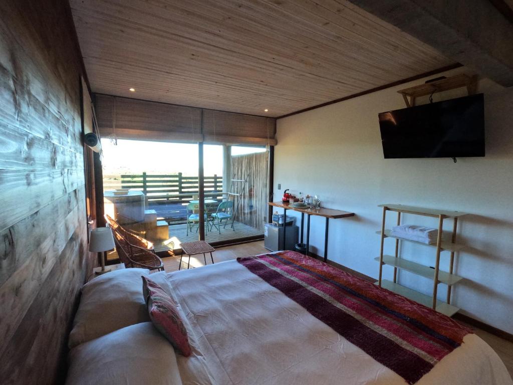 Postel nebo postele na pokoji v ubytování Esfera Pichilemu - Lodge