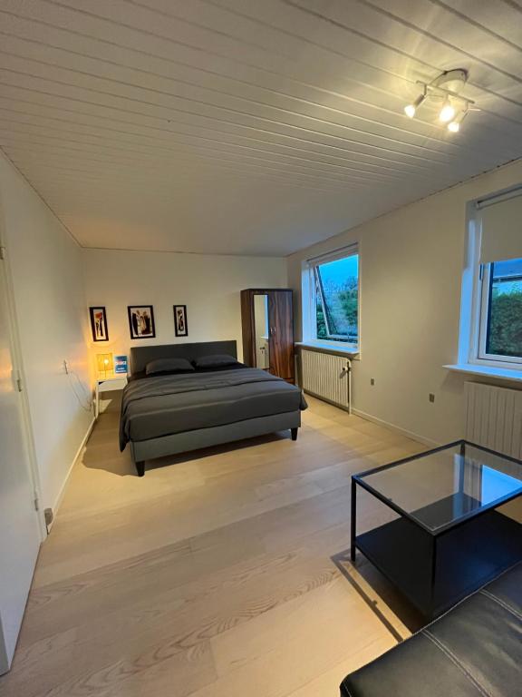 a bedroom with a bed and a coffee table at Room in Billund near Lego House & Legoland in Billund