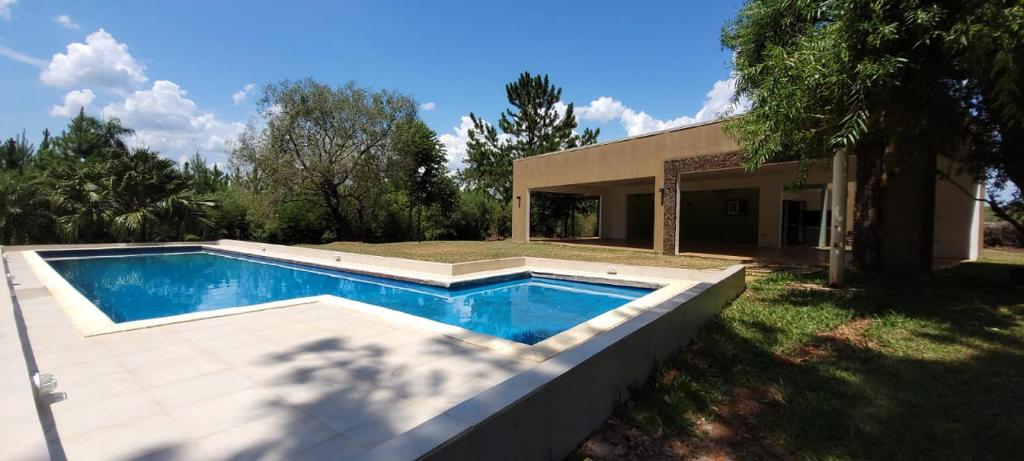 a swimming pool in front of a house at Quinta Germania in Garupá
