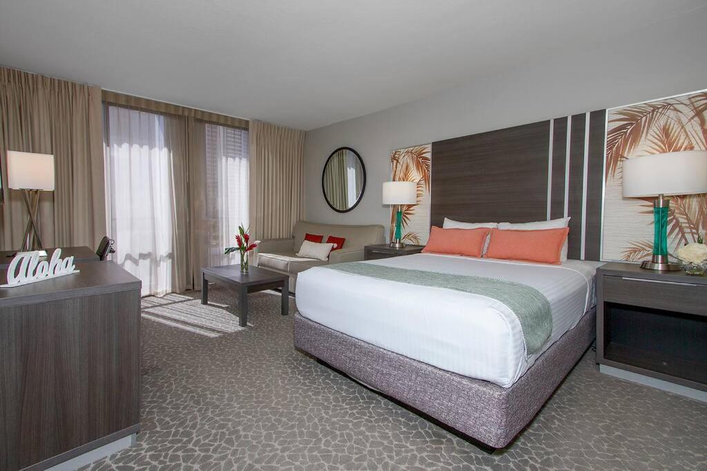 a hotel room with a large bed and a television at Modern studio Across From Hilton lagoon beach PW920 in Honolulu