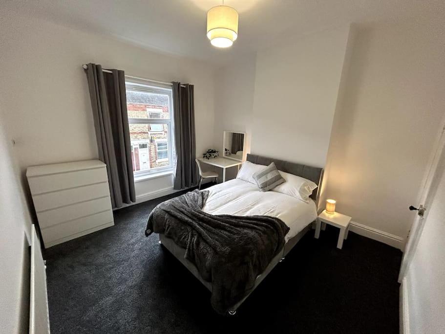 a bedroom with a bed and a window at Bright Home From Home in Stoke on Trent