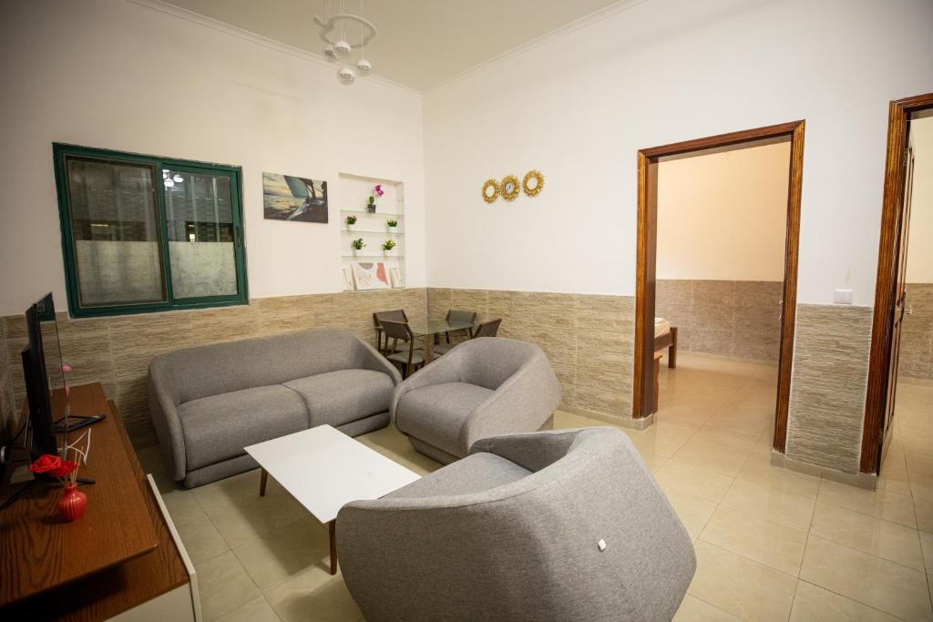 a living room with two chairs and a table at YUPOP APARTAMENTO in São Tomé