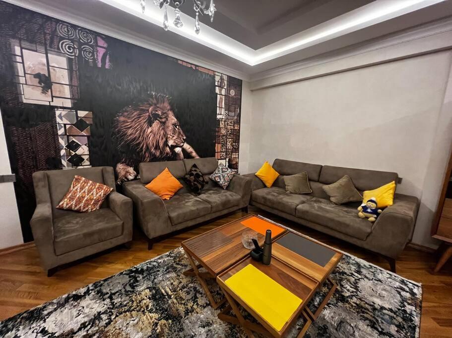 a living room with two couches and a table at Park Azure 463 in Baku