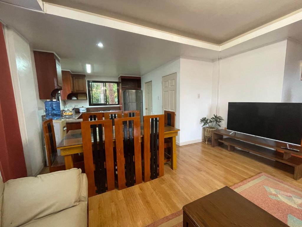 a living room with a large flat screen tv at 2nd Floor- 3BR camp John Hay Unit For Rent in Baguio