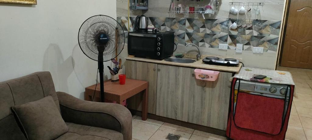a kitchen with a fan next to a counter at الساحل الشمالي in El Alamein