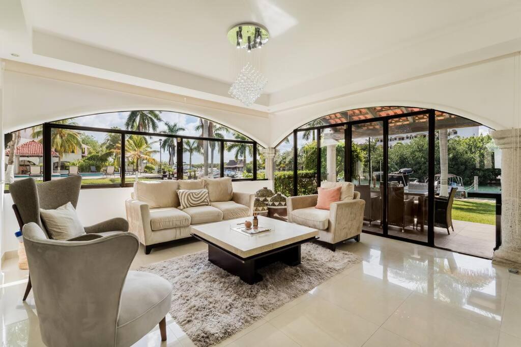 a living room with a couch and chairs and a table at Stylish Lagoon front Villa by Casa Paraiso in Cancún