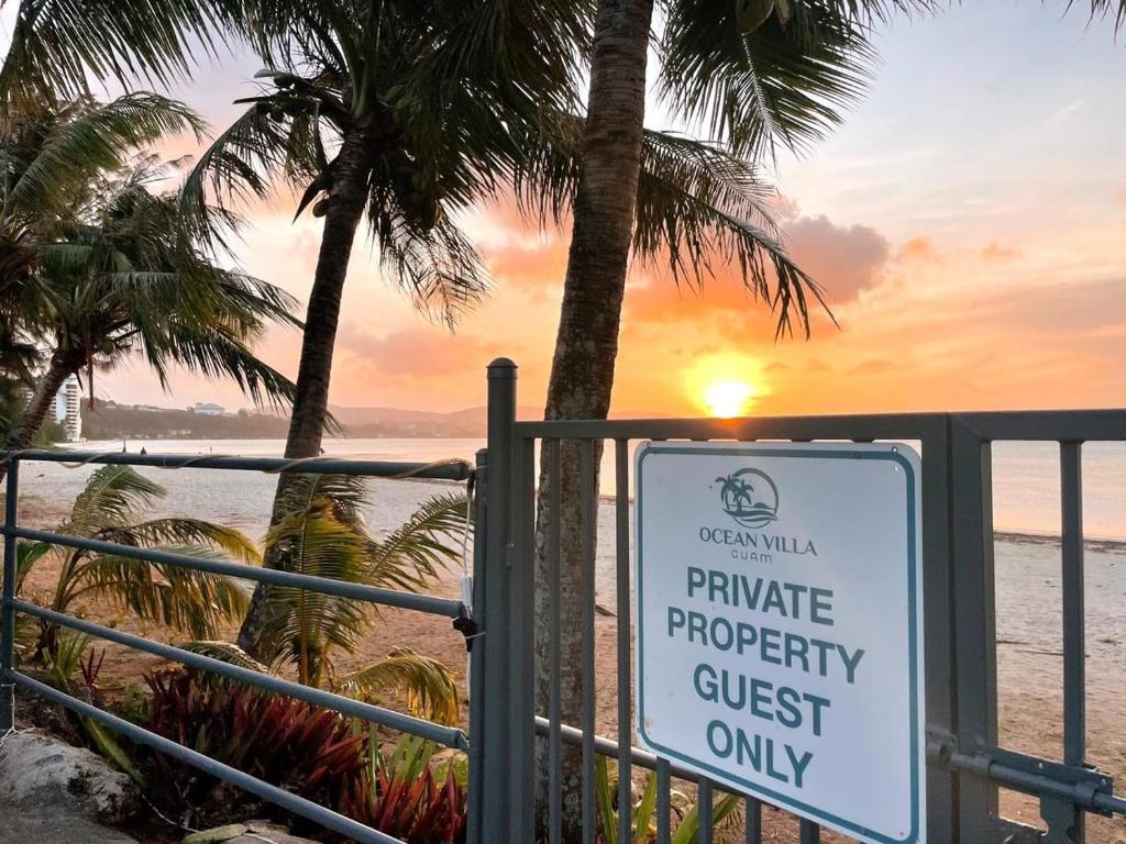 a sign that reads private property guest only on the beach at Ocean Villa Guam in Tamuning